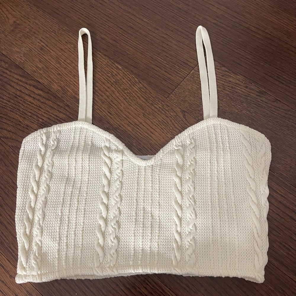 Selling a brand new Zara cropped tank top. It is a cream color and size M.